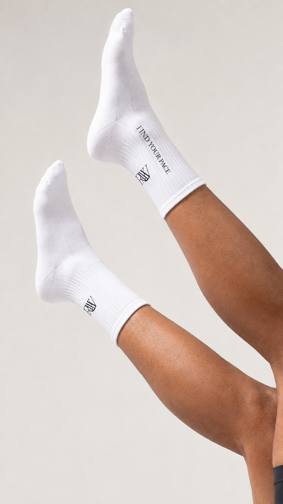 White RAW performance socks photographed in a bright studio